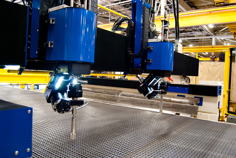 Dual head waterjet fabricating components.