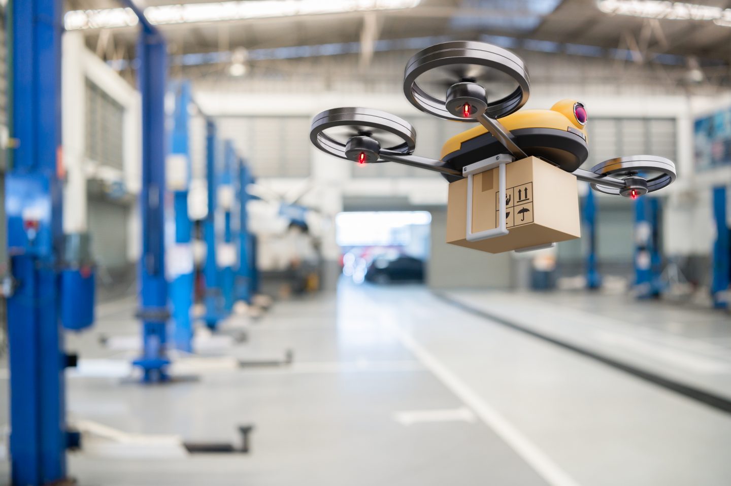 Drone delivering package in warehouse.