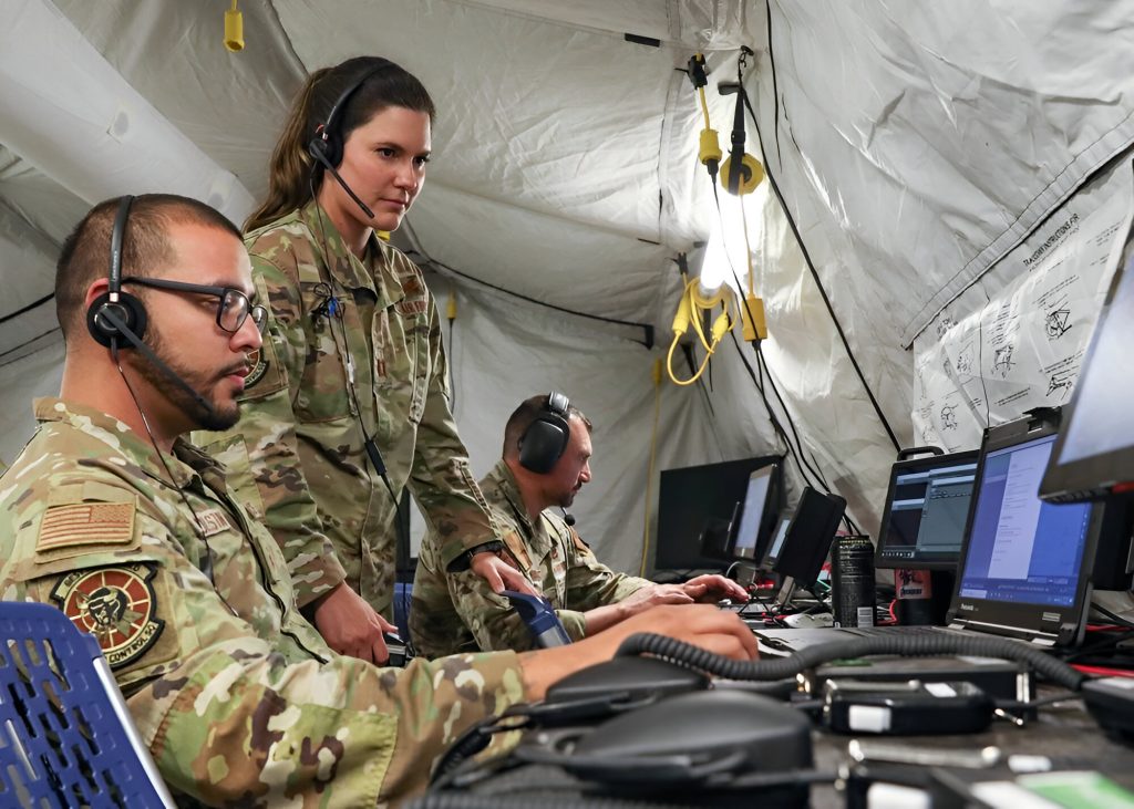 Airmen and Soldiers monitor multiple data feeds inside a forward Tactical Operations Center-Light during Project Convergence 22.