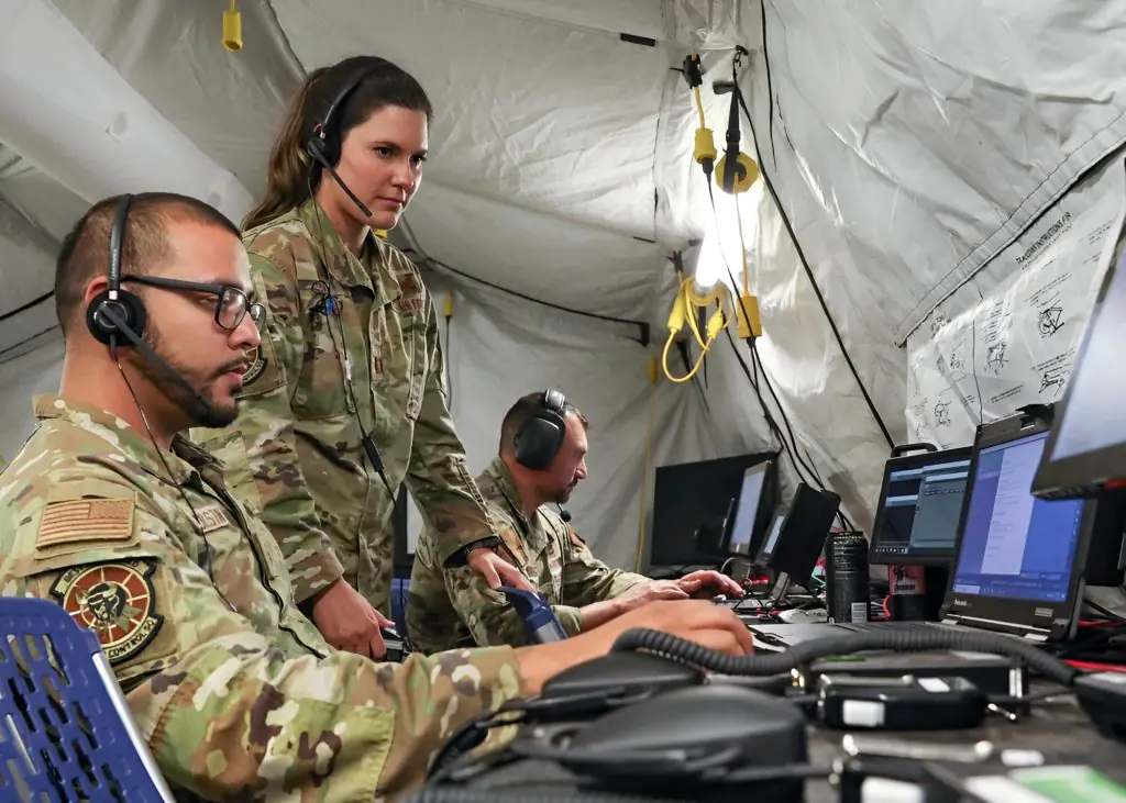 Airmen and Soldiers monitor multiple data feeds inside a forward Tactical Operations Center-Light during Project Convergence 22.